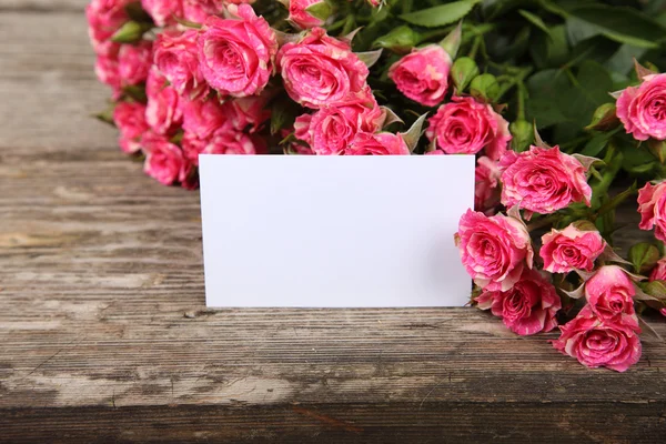 Pink roses and greeting card — Stock Photo, Image