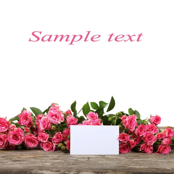 Rosas rosadas y tarjeta de felicitación —  Fotos de Stock