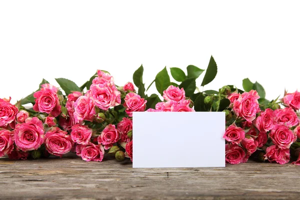 Rosa rosas e cartão de saudação — Fotografia de Stock