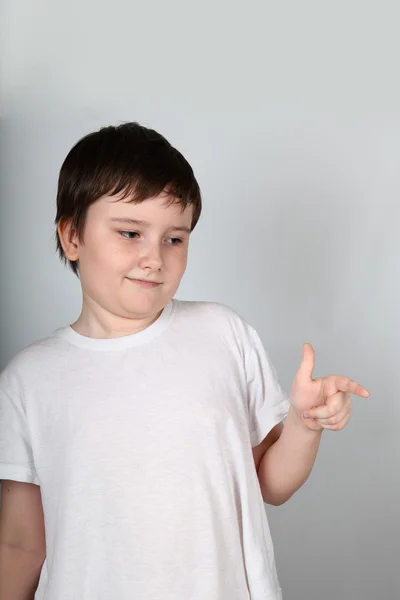 Boy shows his finger to the side — Stock Photo, Image