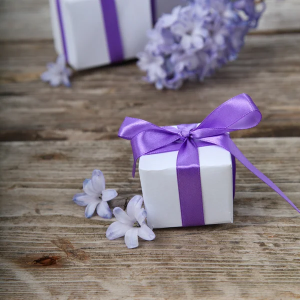 Geschenkdozen met bogen en blauwe hyacint — Stockfoto