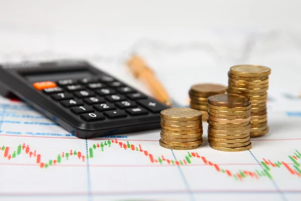 Calculator and stacks of coins — Stock Photo, Image