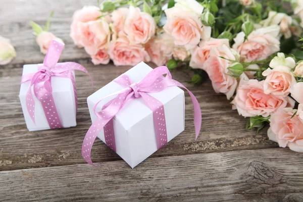 Bouquet of pink roses and gift — Stock Photo, Image