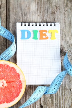 Ölçüm bandı, defter ve greyfurt 