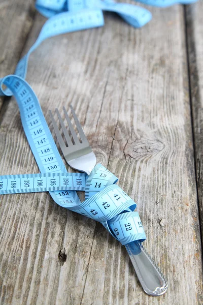 Fork and blue measuring tape — Stock Photo, Image