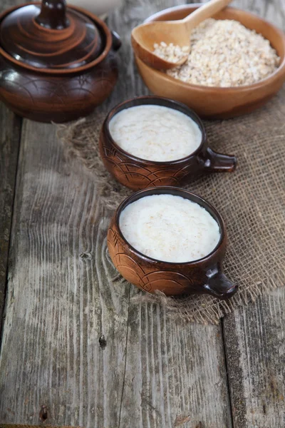 Oatmeal on old wooden table — Stock Photo, Image