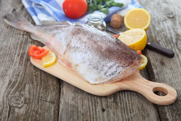 Raw fish on a cutting board — Stock Photo, Image