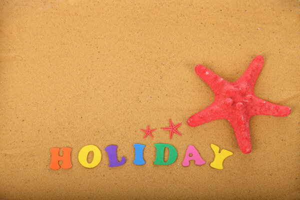 Word "holidays" and starfish