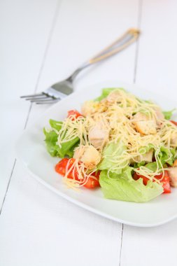Sezar salatası beyaz bir plaka 