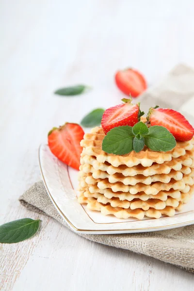 Waffles with strawberries on a wooden table — Stock Photo, Image