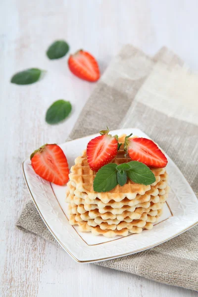 Waffles with strawberries on a wooden table — Stock Photo, Image