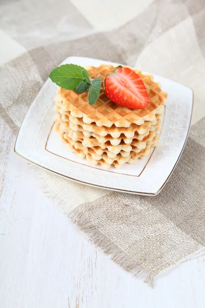 Waffles with strawberries on a wooden table — Stock Photo, Image