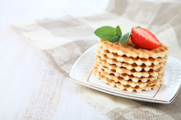 Waffles with strawberries on a wooden table — Stock Photo, Image