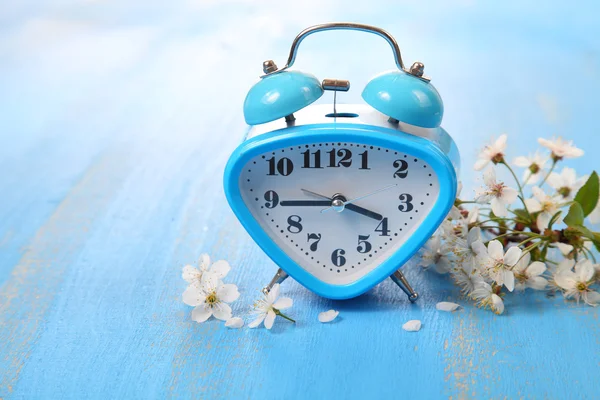 Flowers of cherry and alarm clock — Stock Photo, Image