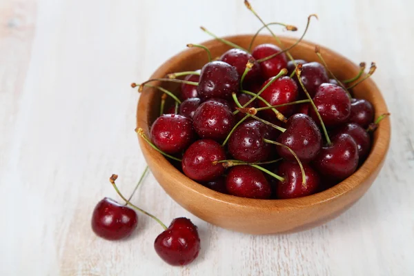 Ripe cherry in a wooden bowl Stock Image