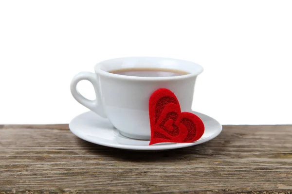 Cup of coffee and heart on a wooden table — Stock Photo, Image