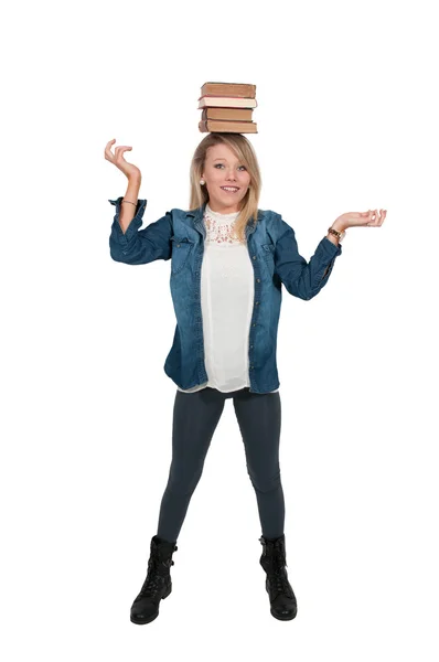 Woman balancing books — Stock Photo, Image