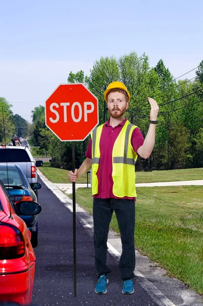 Workman med stoppskylt — Stockfoto