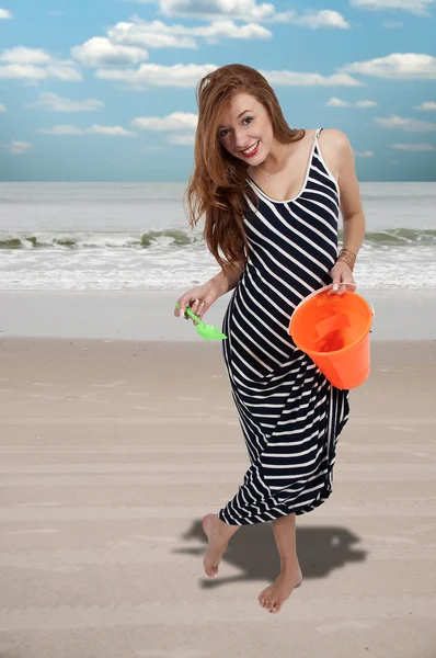 Woman with a sand pail — Stock Photo, Image