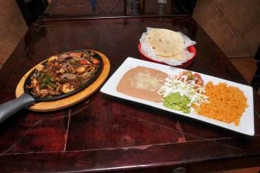 Authentic and traditional Mexican cuisine known as steak fajitas clipart