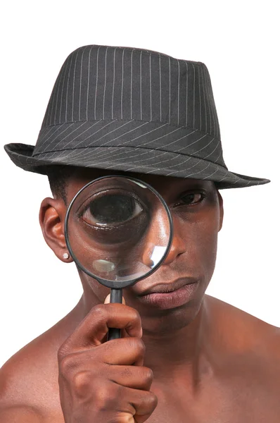 Zwarte man kijken door een vergrootglas — Stockfoto