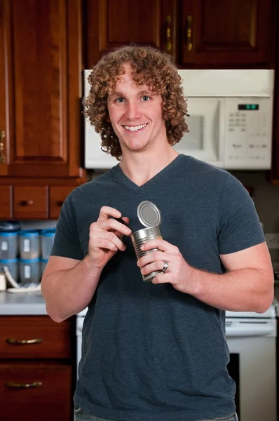 Man eating canned food — Stock Photo, Image