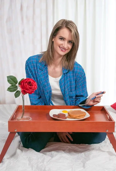 Frau frühstückt im Bett — Stockfoto