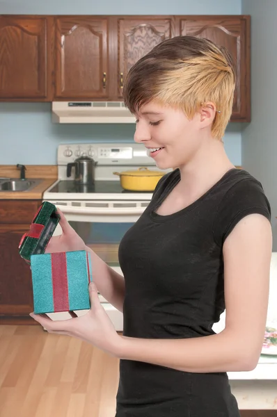 Beautiful woman opening a present — Stock Photo, Image