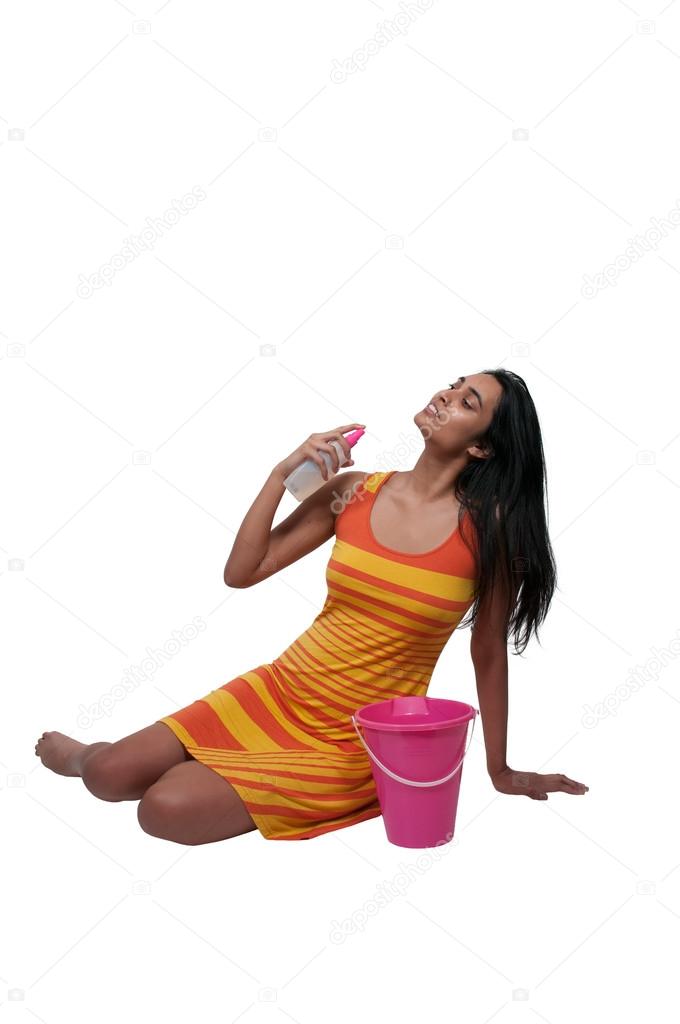 Woman applying suntan lotion