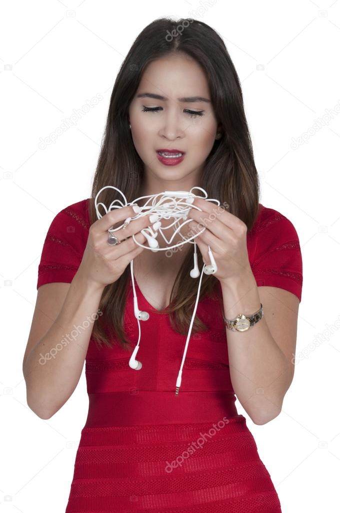 Woman with tangled headphones