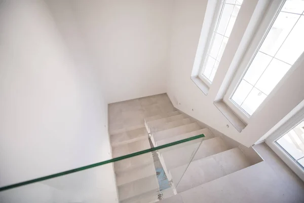 Stairs at modern white home with glass