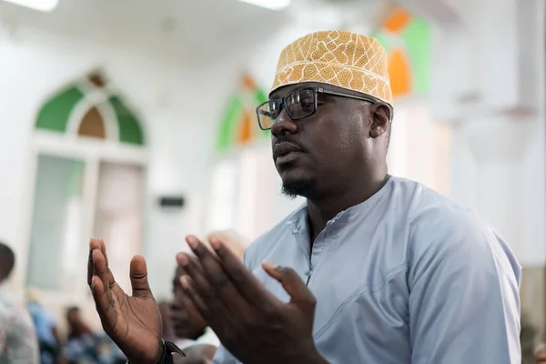 Black Muslim adult man praying inside mosque on Friday prayer