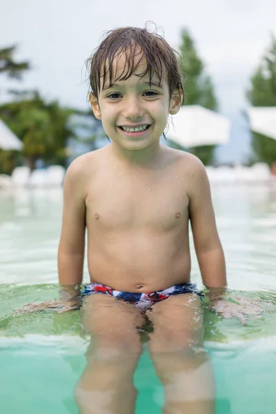 Niño pequeño niño chapoteando en la piscina divertirse actividad de ocio — Foto de Stock
