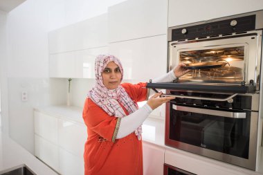 Geleneksel Müslüman kadın soba kullanıyor