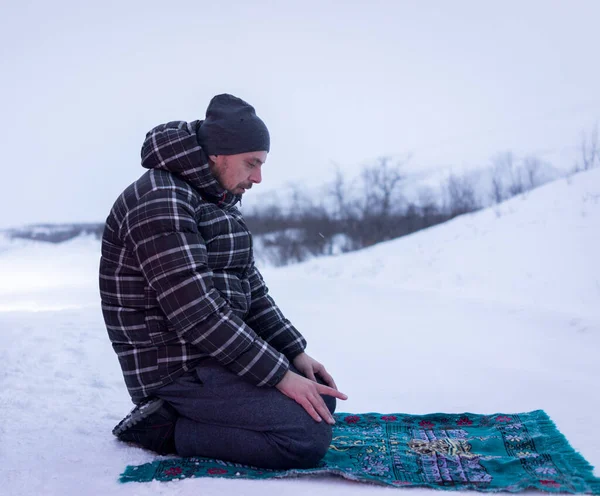 Мусульманський мандрівник молиться в зимовій горі, високоякісна фотографія Стокове Зображення