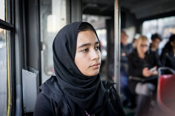 Chica de Oriente Medio montando transporte público en la ciudad — Foto de Stock