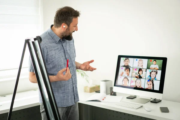 Male teacher having online conference with school children — Stock Photo, Image