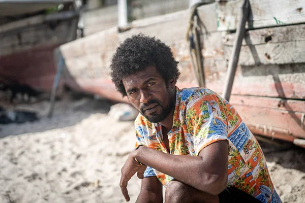Candid black fisherman on coast near ocean alone — Zdjęcie stockowe