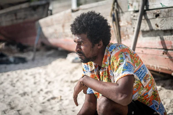 Candid black fisherman on coast near ocean alone — Stockfoto