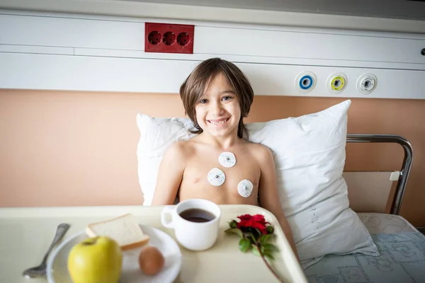 Little cute boy in hospital at bed Stock Photo