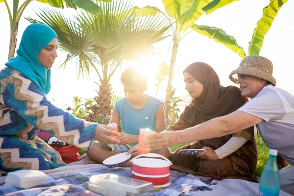 Счастливая семья наслаждается пикником на пляже — стоковое фото