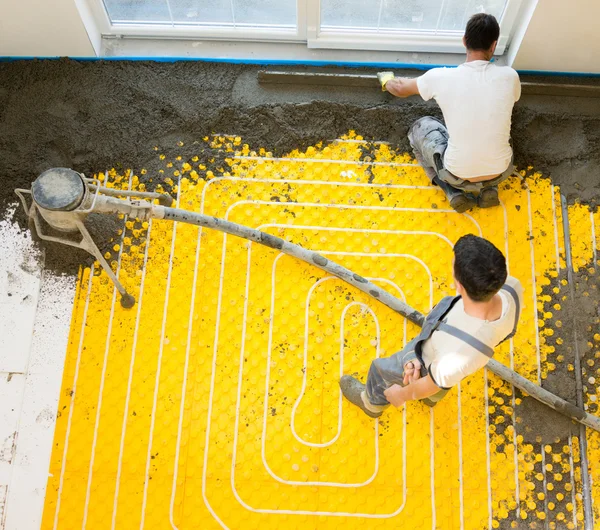 Worker installing underfloor heating system — Stock Photo © .shock