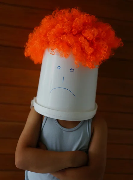 Angry boy with bin on his head — Stock Photo, Image