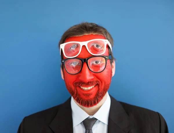 Young man portait with red painted face — Stock Photo, Image