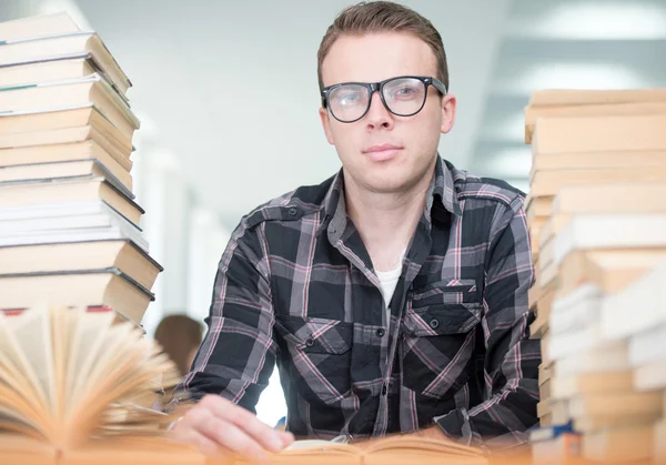 Giovane uomo che studia nella biblioteca del college — Foto Stock