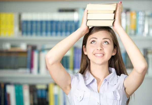 Beautiful girl studying in college library — Stock Photo, Image