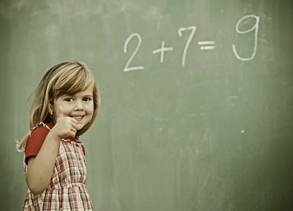 Little girl at school having education activities — Stock Photo, Image