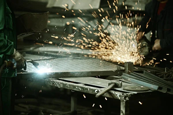 Worker cutting iron with professional tool — Stock Photo, Image