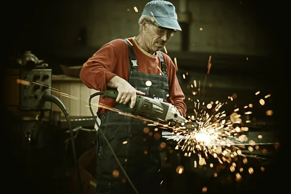 Werknemer snijden ijzer met professioneel gereedschap — Stockfoto