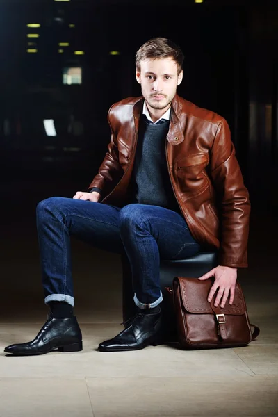 Fashionable young man with leather clothes on